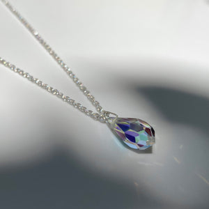 Silver necklace with multifaceted aurora borealis crystal pendant. Chain is made from polished 925 (sterling) silver, pendant made from crystal glass. The length of the chain is 50 cm, the pendant is 18mm long.